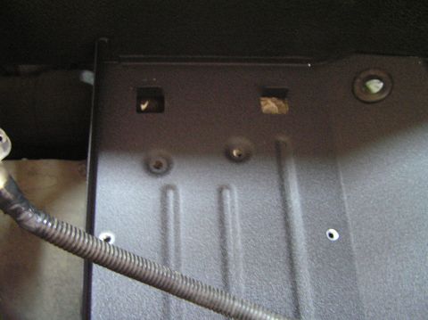 2000 Ford Excursion - Detail of a vehicle's interior paneling, showing mounting points and conduit.