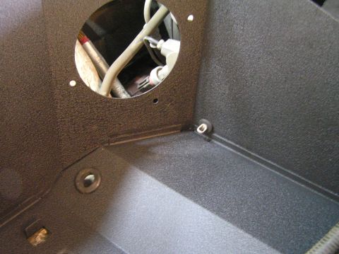 2000 Ford Excursion - Close-up view of a textured black housing with internal wiring and hoses visible through an opening.