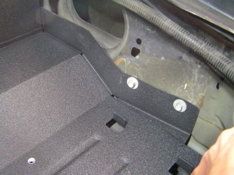 2000 Ford Excursion - Close-up of an aftermarket battery tray installation, highlighting the mounting hardware and tray texture.