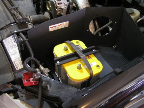 2000 Ford Excursion - Close-up of a vehicle's engine bay, a yellow battery and a custom air intake system.
