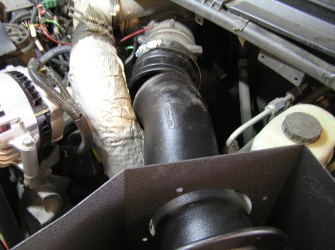 2000 Ford Excursion - Close-up view of an aftermarket intake system installed in a vehicle's engine bay.