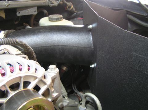 2000 Ford Excursion - Close-up view of an engine bay, focusing on an aftermarket air intake system and associated components.