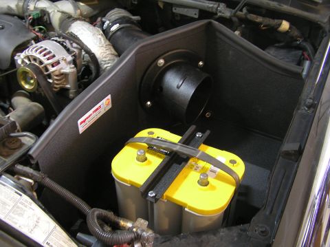 2000 Ford Excursion - Engine bay view showing an AFE Stage II intake system and a yellow top Optima battery.