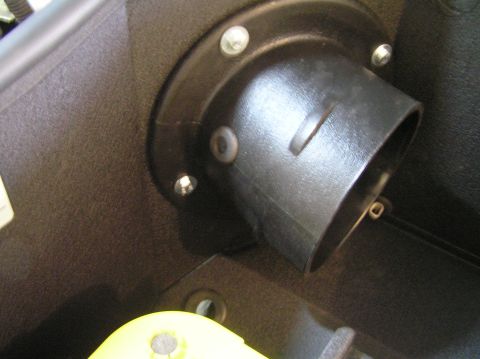 2000 Ford Excursion - Aftermarket air intake tube connection to a black plastic housing, likely part of an engine bay component.