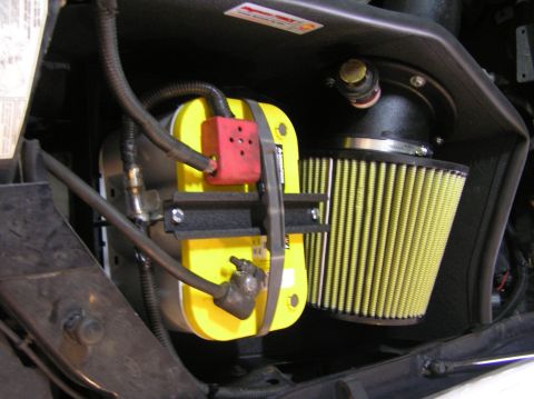 2000 Ford Excursion - Close-up of an AFE Stage II Intake and ProGuard Filter assembly, a yellow battery and red terminal cover.