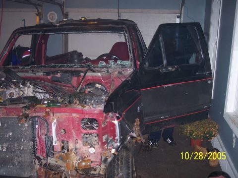 1994 Ford Bronco - This 1994 Ford Bronco shows significant front-end damage and a dismantled engine compartment.