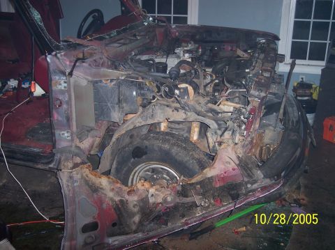 1994 Ford Bronco - The front of this vehicle is completely destroyed, exposing the engine and suspension components. A date stamp indicates the photo was take…