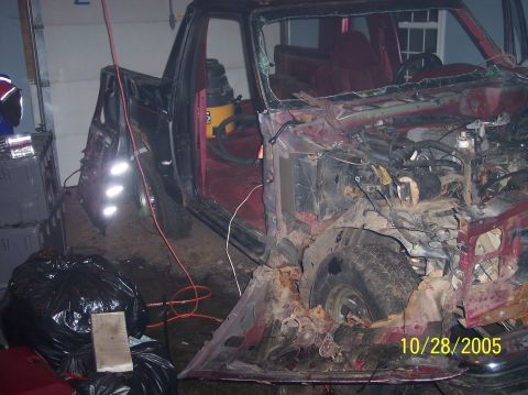 1994 Ford Bronco - This heavily damaged truck shows significant front-end destruction and an open driver's door.