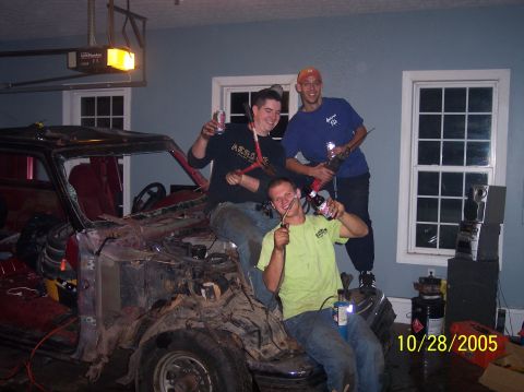 1994 Ford Bronco - Friends celebrate around a disassembled vehicle, possibly during a project or event.
