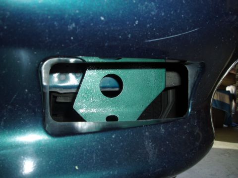 1995 Ford Taurus - Close-up of a teal 1995 Ford Taurus front bumper bracket.