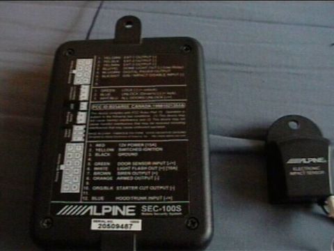 1994 Ford Probe - Alpine SEC-100S car alarm module and electronic impact sensor shown with wiring diagram and serial number.