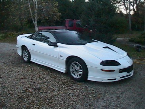 1996 Chevrolet Camaro - This white 1996 Chevrolet Camaro features a black convertible top and is shown from a 3/4 front angle.
