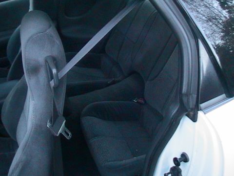 1996 Chevrolet Camaro - Interior view of the rear seats and seatbelt mechanism.