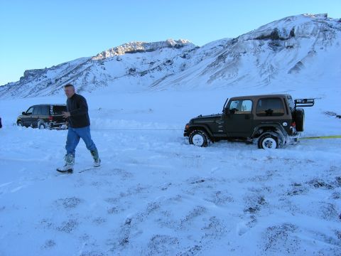 2001 Jeep Wrangler - A 2001 Jeep TJ is stuck in the snow and being pulled by another vehicle.