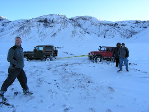 2001 Jeep Wrangler - Two Jeeps are stuck in the snow, with one vehicle attempting to tow the other out.