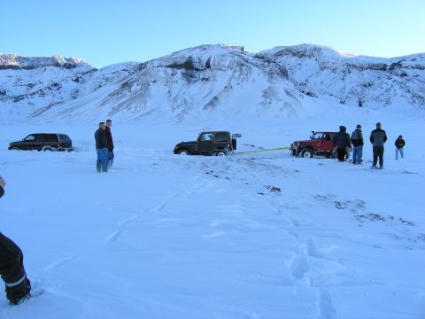 2001 Jeep Wrangler - Two Jeeps are stuck in the snow, with one vehicle attempting to tow the other out.