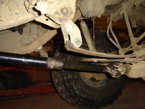 1992 Ford Bronco - Undercarriage view of a 1992 Ford Bronco, revealing suspension components and a tire.