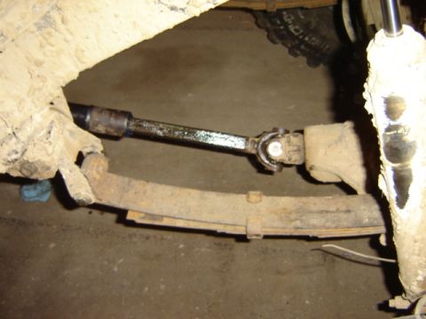 1992 Ford Bronco - Close-up view of a driveshaft U-joint and leaf spring, likely from a truck or SUV.