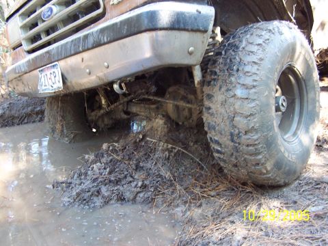 1987 Ford Bronco - This 1987 Ford Bronco is deeply stuck in mud, with its front end submerged and tires caked in dirt.