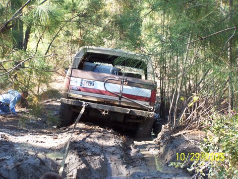1987 Ford Bronco - Ford Bronco is stuck in the mud while off-roading.