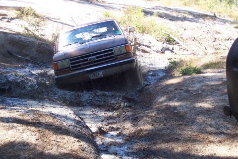 1987 Ford Bronco - This 1987 Ford Bronco is navigating a challenging muddy terrain.