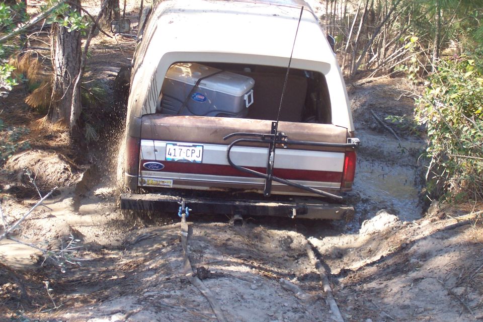 Ford Bronco stuck in mud, rear view. License plate 417 CPJ visible