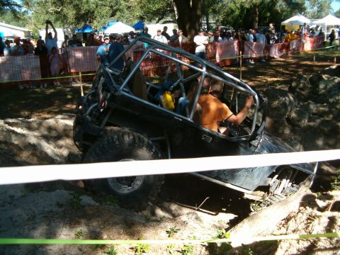 1991 Ford Bronco - This heavily modified off-road vehicle navigates a challenging obstacle course during an event.
