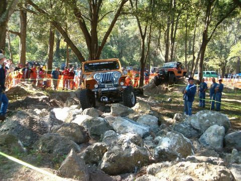 1991 Ford Bronco - Off-road vehicles tackle a challenging rock crawling course during an event.