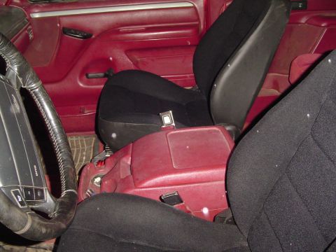 1994 Ford Bronco - Interior view of a vehicle with red upholstery and black seats.