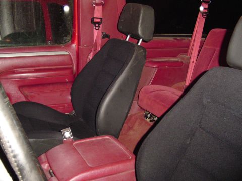 1994 Ford Bronco - Interior of a 1994 Ford Bronco with red upholstery and black seats.