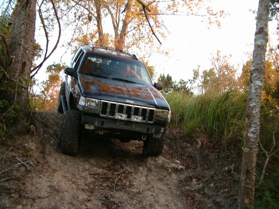 Black Jeep Grand Cherokee on a dirt trail, front view