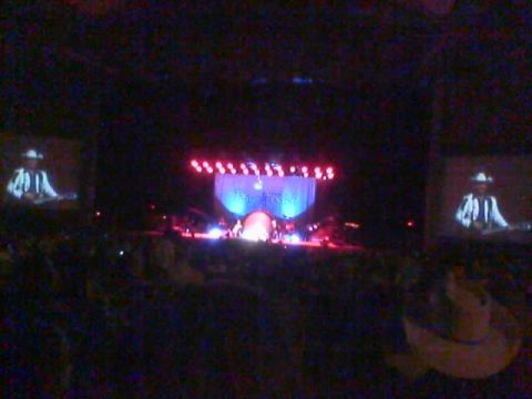 1986 Ford Bronco - A concert scene with a stage, lighting, and screens displaying a cowboy figure.
