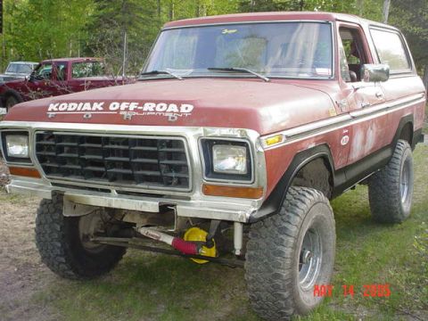 1978 Ford Bronco - This 1978 Ford Bronco features off-road modifications and is parked outdoors with another vehicle in the background.