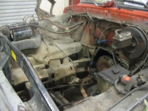 1978 Ford Bronco - The engine bay of a 1978 Ford Bronco shows significant disassembly and wear.