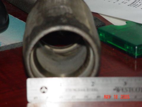 1978 Ford Bronco - A ruler is placed in front of a metal exhaust pipe, with a date stamp visible on the ruler.