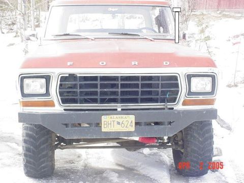 1978 Ford Bronco - This 1978 Ford truck features a prominent grille and a custom black bumper, seen here in a snowy environment.