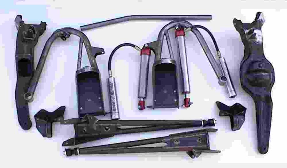 Various suspension components laid out, including shocks, control arms, and a differential housing