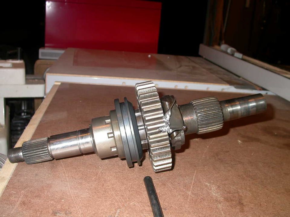 Oil pump retainer bracket bent into drive sprocket, caused by oil pump siezing to output shaft