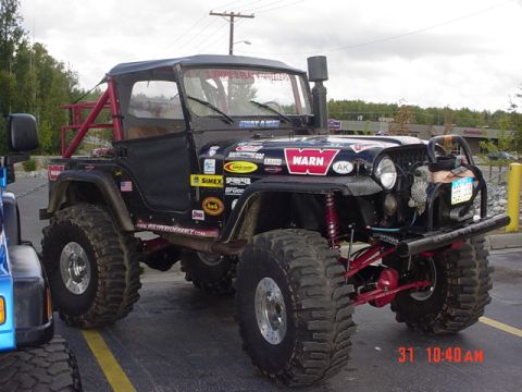 1976 Jeep CJ7 - Modified 1976 Jeep CJ7 parked outdoors, showing off its off-road capabilities and custom decals.