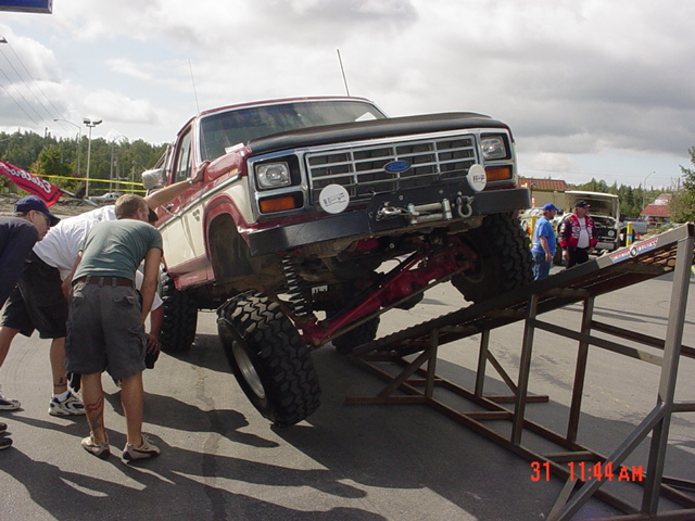Lifted 1980 Ford F-Series truck with custom suspension on metal ramps