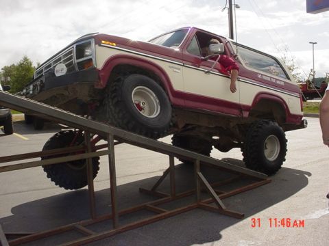 1976 Jeep CJ7 - This lifted 1980 Ford Bronco is positioned on a ramp, its off-road capabilities.