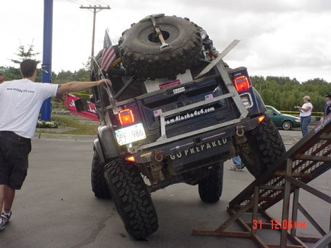 1976 Jeep CJ7 - A heavily modified Jeep Wrangler JK is positioned on a ramp, its off-road capabilities.