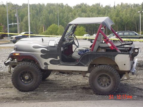 1976 Jeep CJ7 - This Jeep CJ has flame decals on the hood and a roll cage with a fire extinguisher attached.