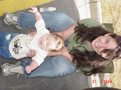 1976 Jeep CJ7 - A woman and a baby are sitting on the ground outdoors. A timestamp is visible in the lower right corner.