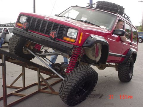 1976 Jeep CJ7 - This red Jeep Cherokee XJ is shown with its suspension flexed on a ramp.