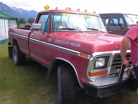 1978 Ford Bronco - 1978 Ford F-Series pickup truck modified for off-road use, seen with another vehicle in the background.