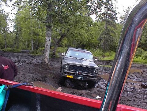 1978 Ford Bronco - A truck navigates a muddy trail, getting stuck in the mire.