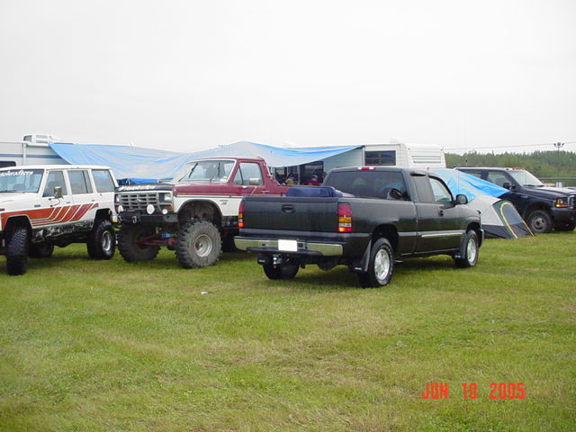 1978 Ford Bronco with lifted suspension parked next to other off-road vehicles