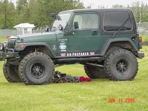 1978 Ford Bronco - This green Jeep Wrangler is equipped for off-road adventures, as indicated by its large tires and "GO PREPARED" decal.