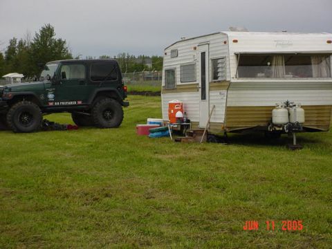 1978 Ford Bronco - A Jeep Wrangler and travel trailer are parked in a grassy area. The photo was taken on June 11, 2005.